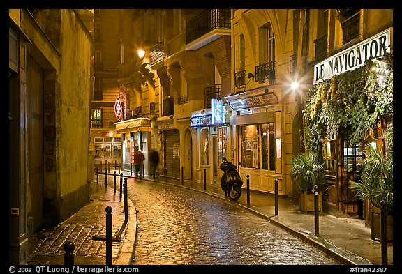 Street With Cobblestone Pavement And Restaurants By Night Quartier