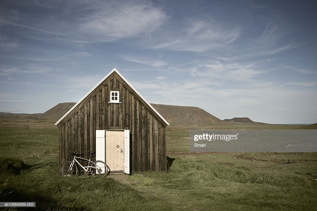 Bicycle Outside Hut Mountain In Background High Res Stock Photo