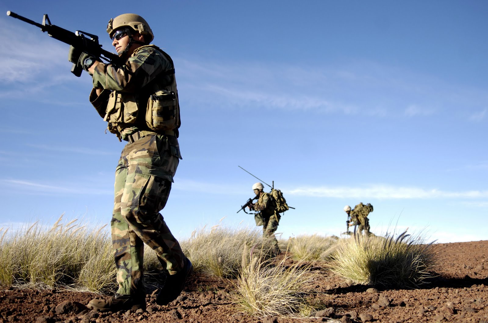 Soldiers patrolling a desert landscape during military exercises