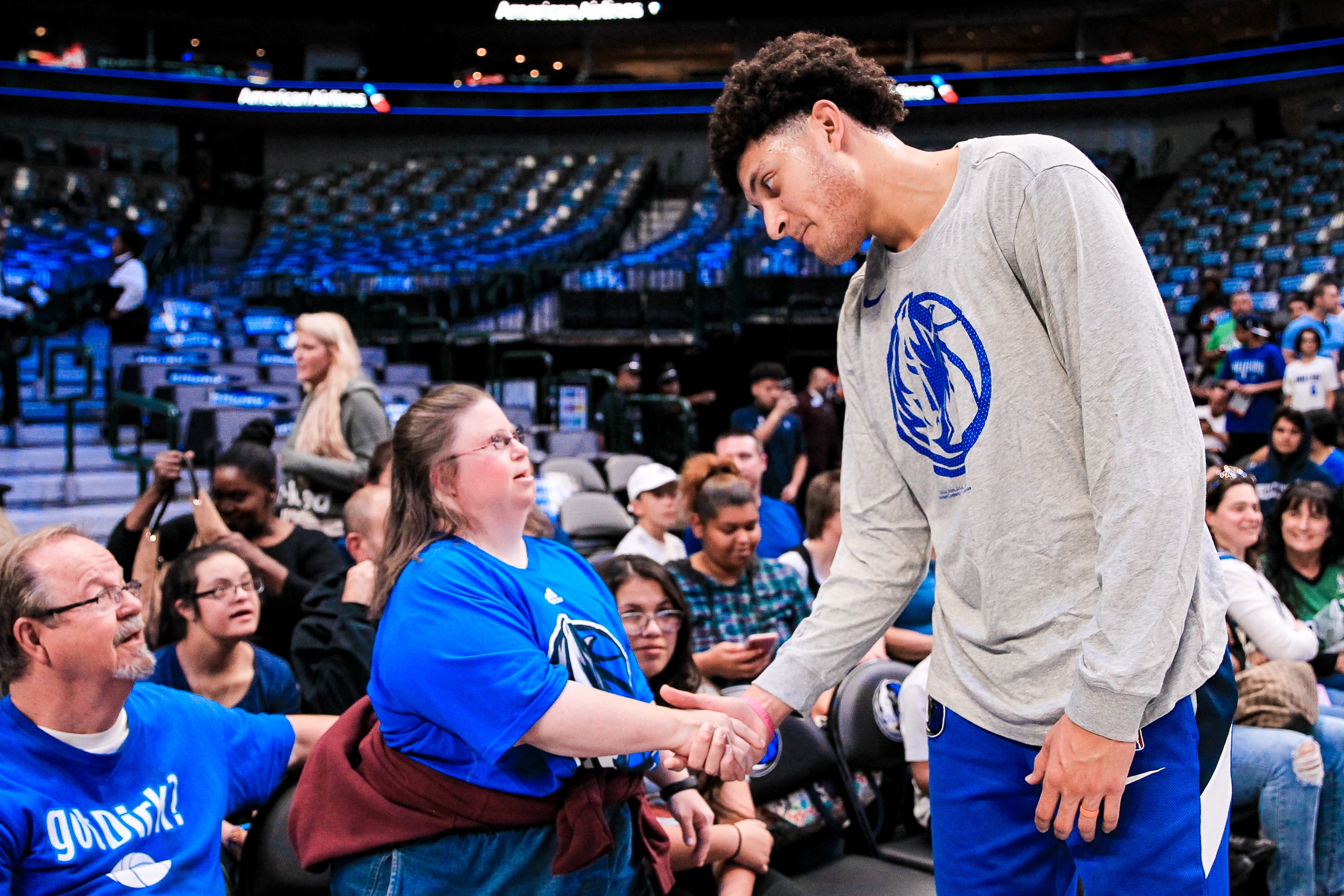 Dallas Mavericks player Justin Jackson shakes hands with a fan