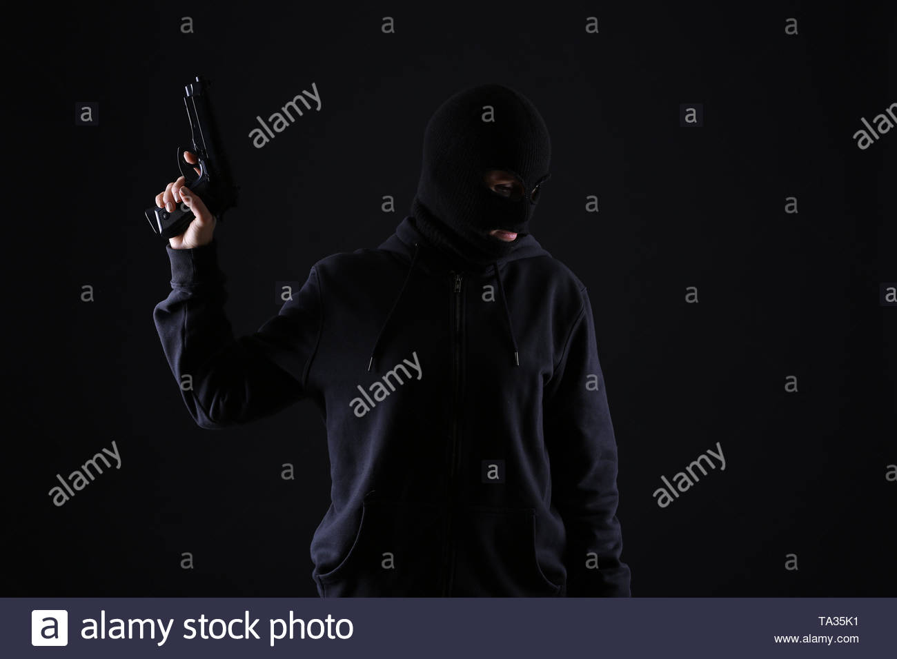 Bandit With Gun On Dark Background Stock Photo