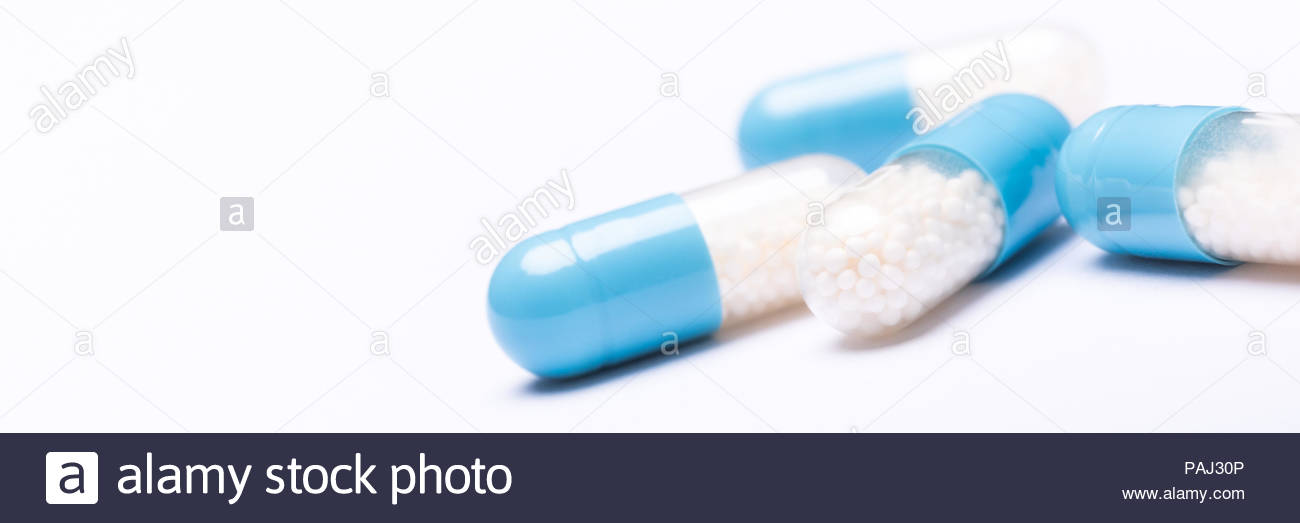 White And Blue Medication Capsules On Background