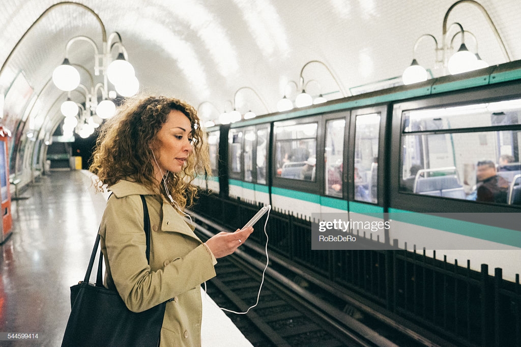 Cheerful Woman On The Phone Subway Train Background Stock Photo