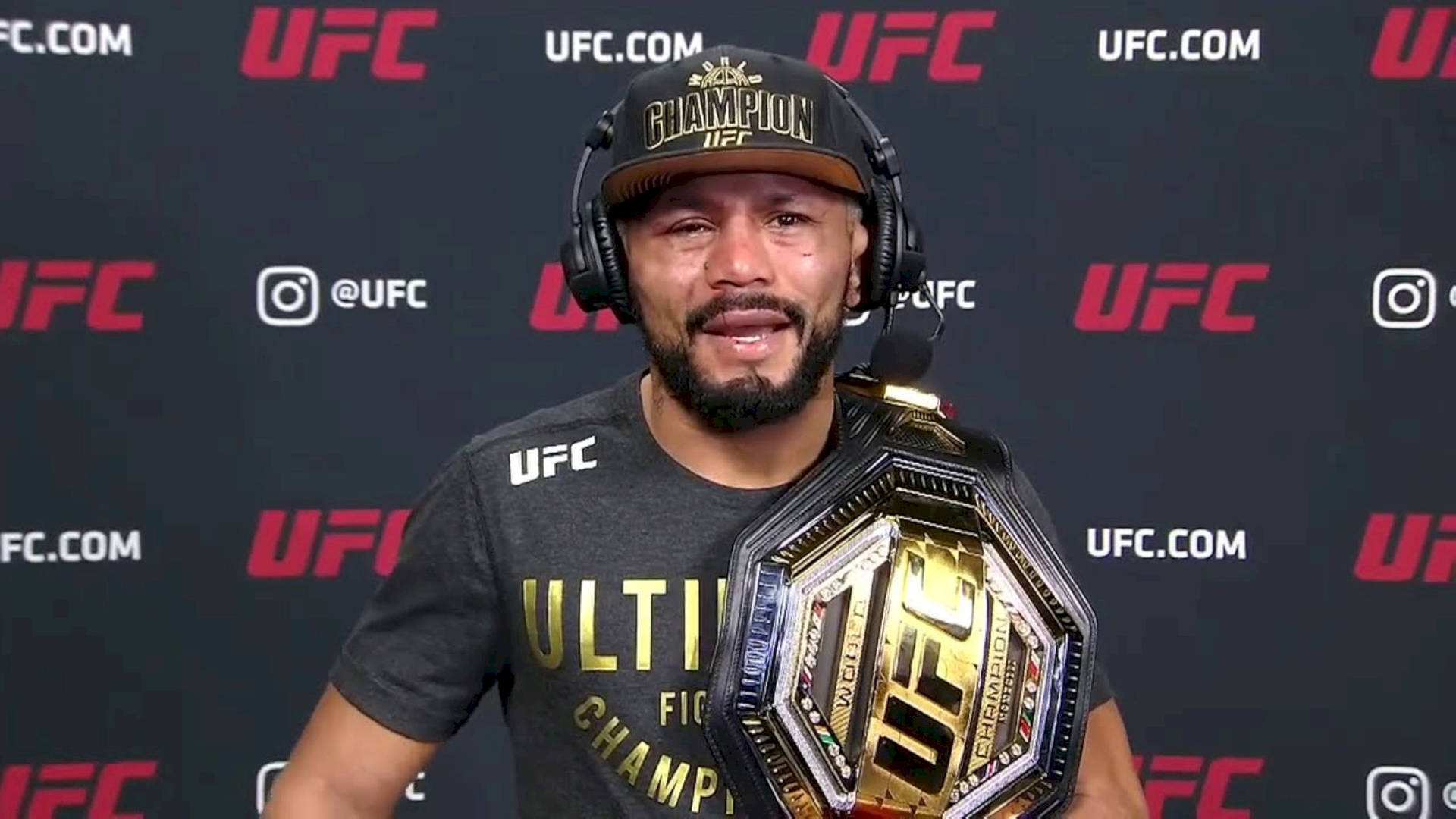 Deiveson Figueiredo Wearing Headset While Holding Championship Wallpaper