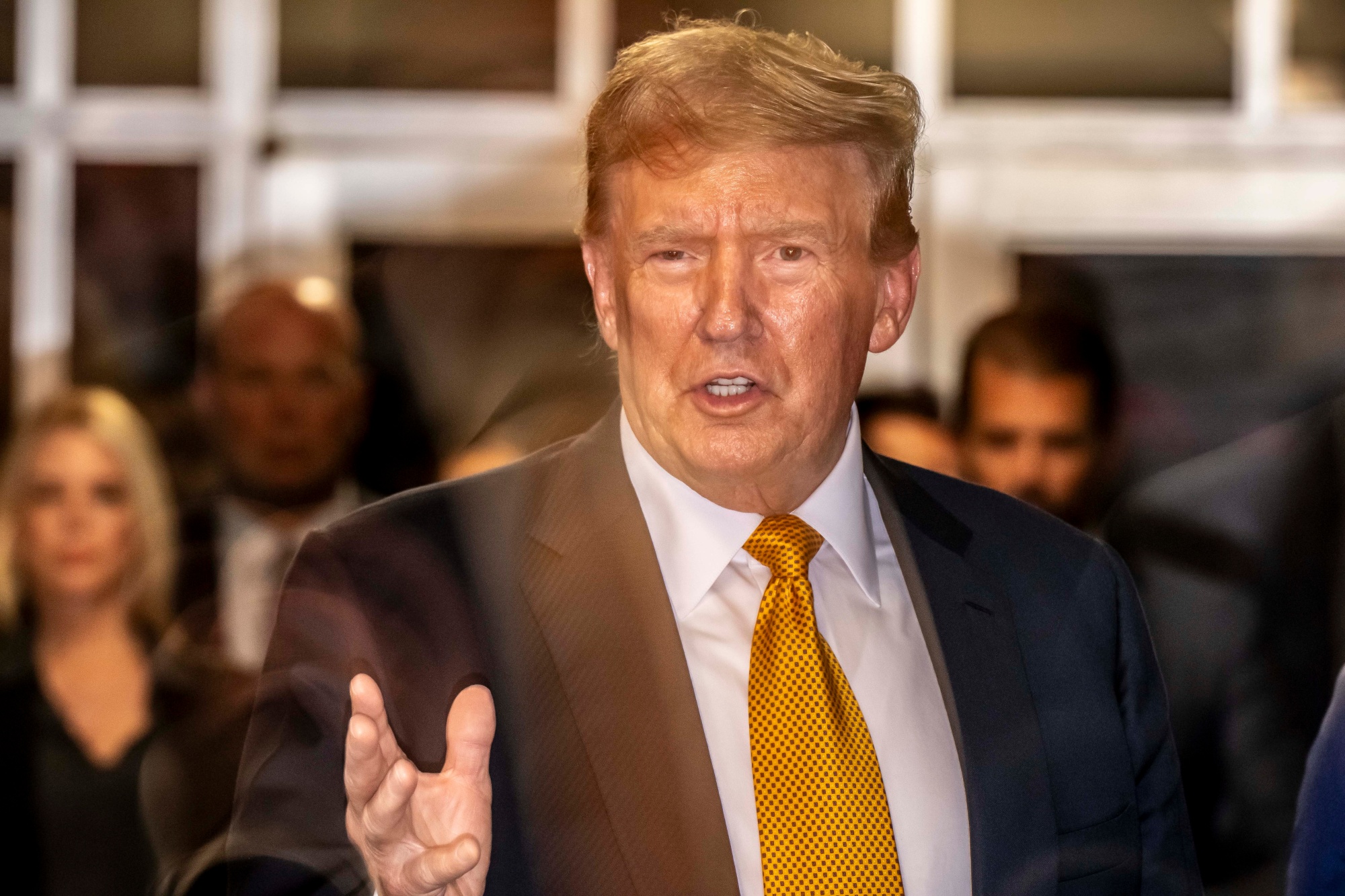 Donald Trump speaking in a crowd