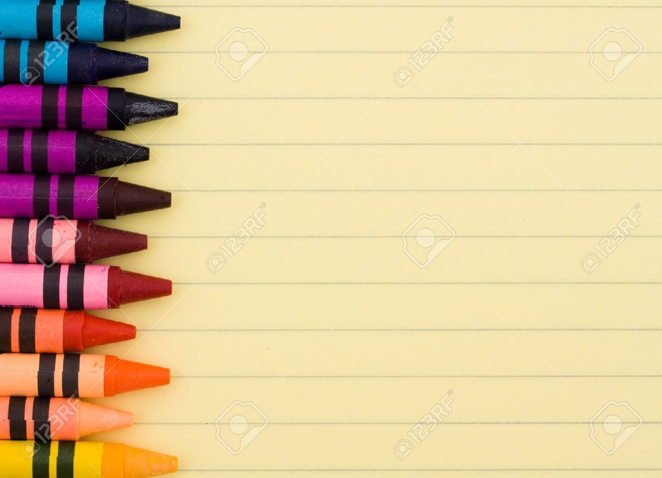 Colorful Crayons On A Sheet Of Lined Paper Education Background