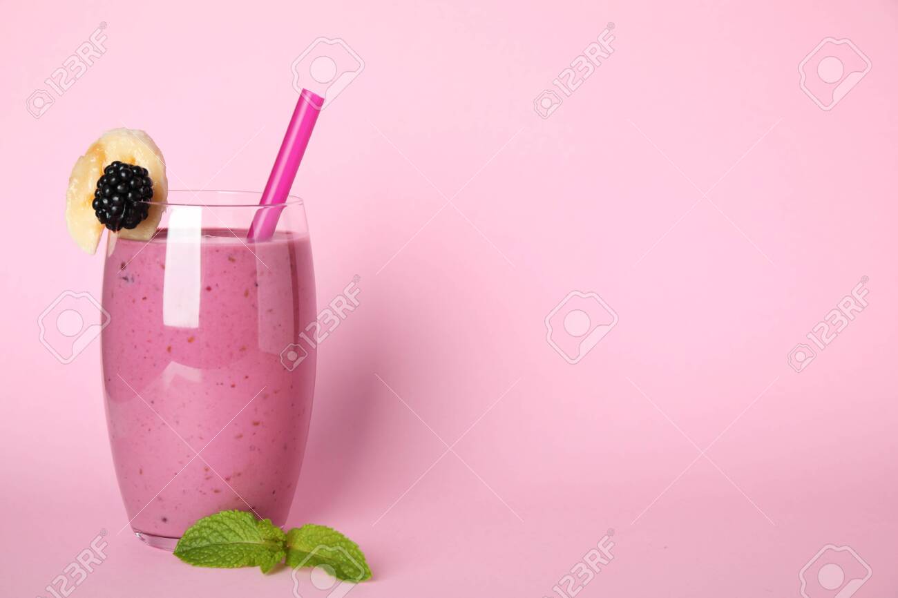 Glass Of Delicious Blackberry Smoothie On Pink Background Space