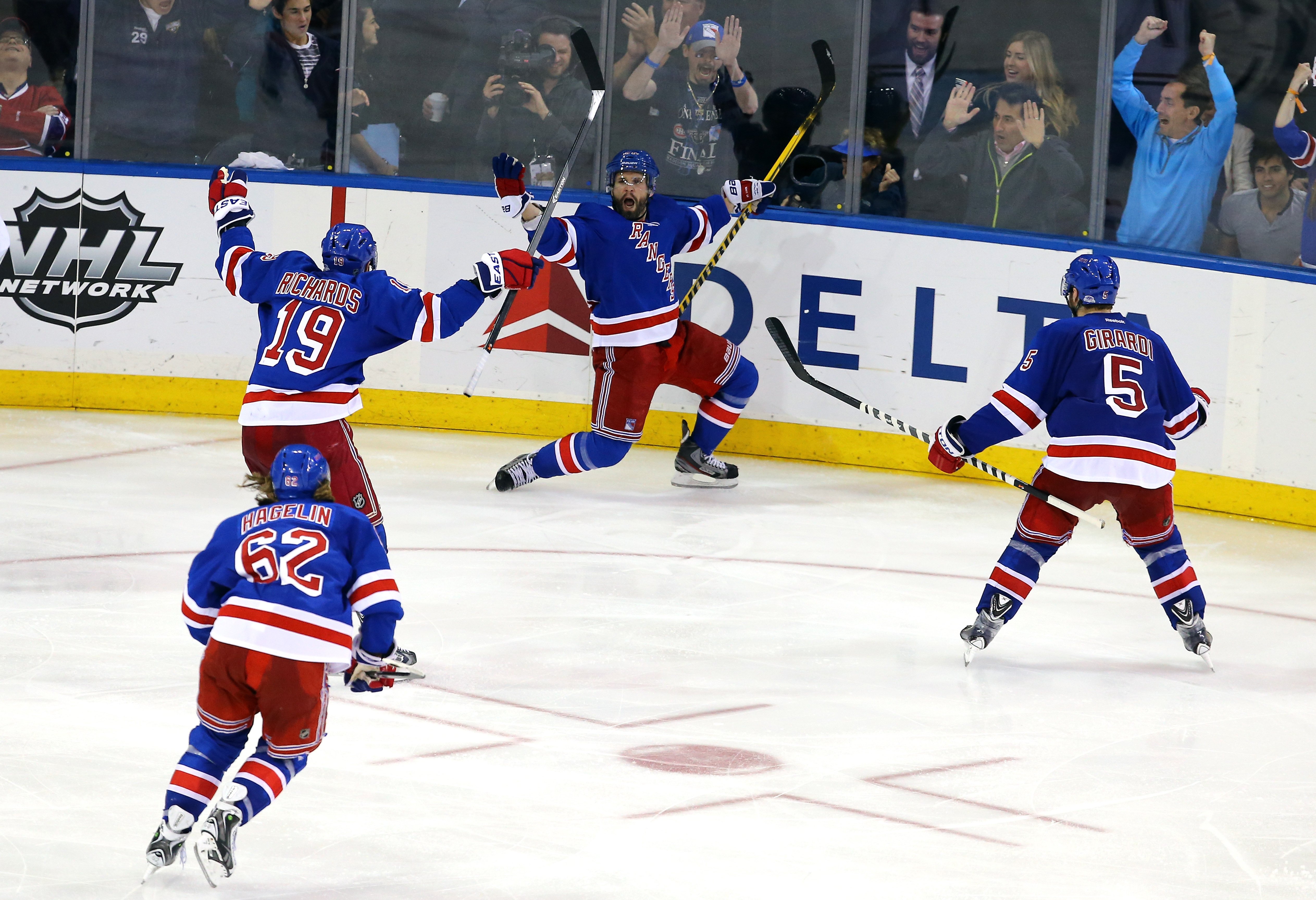 New York Rangers players celebrating a goal on the ice