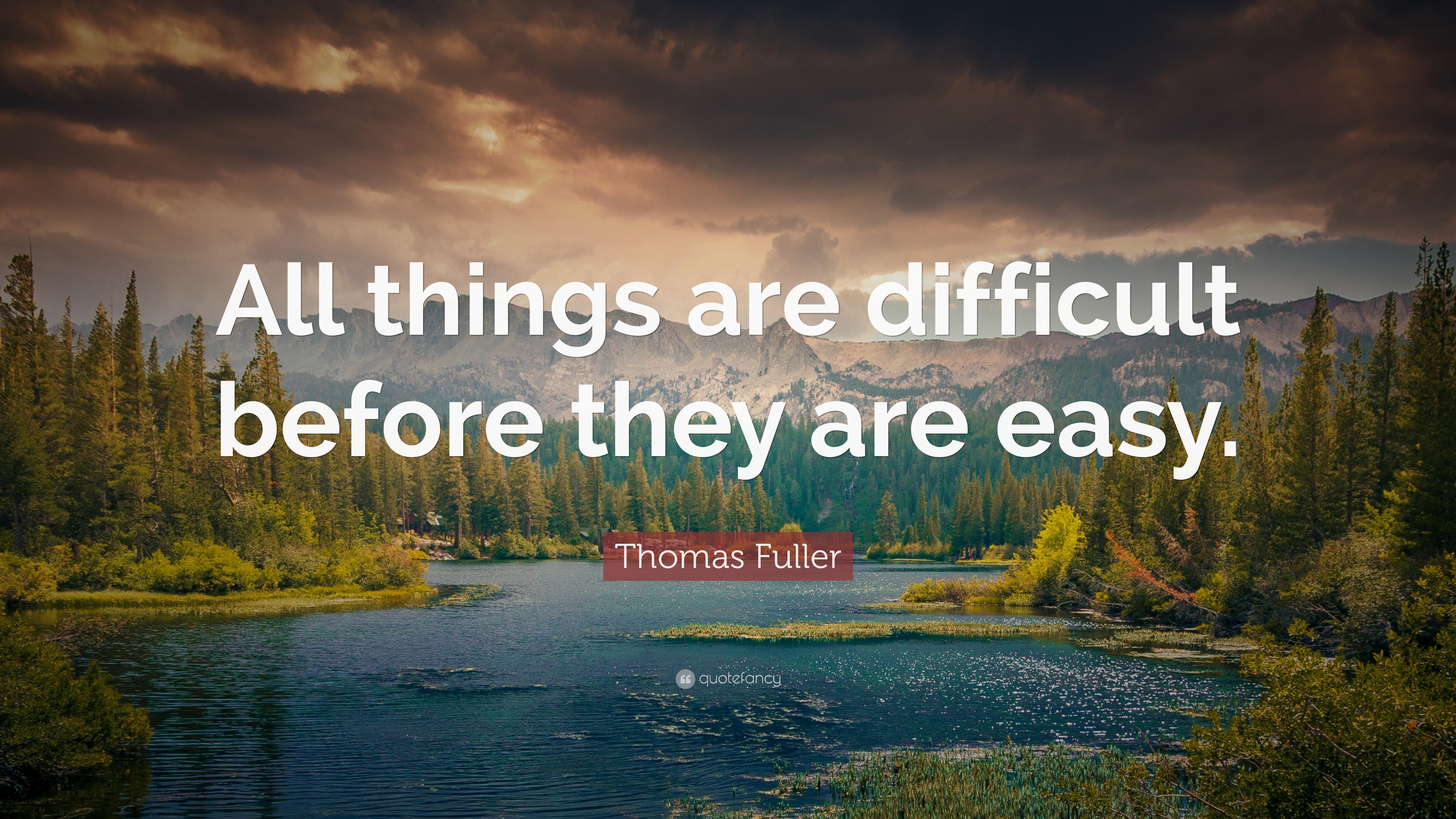 A serene lake nestled amidst a mountain forest, illustrating the quote 'All things are difficult before they are easy' by Thomas Fuller