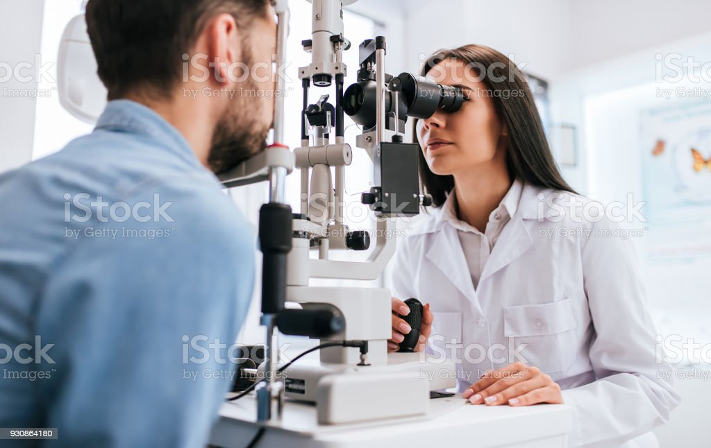 Doctor And Patient In Ophthalmology Clinic Stock Photo