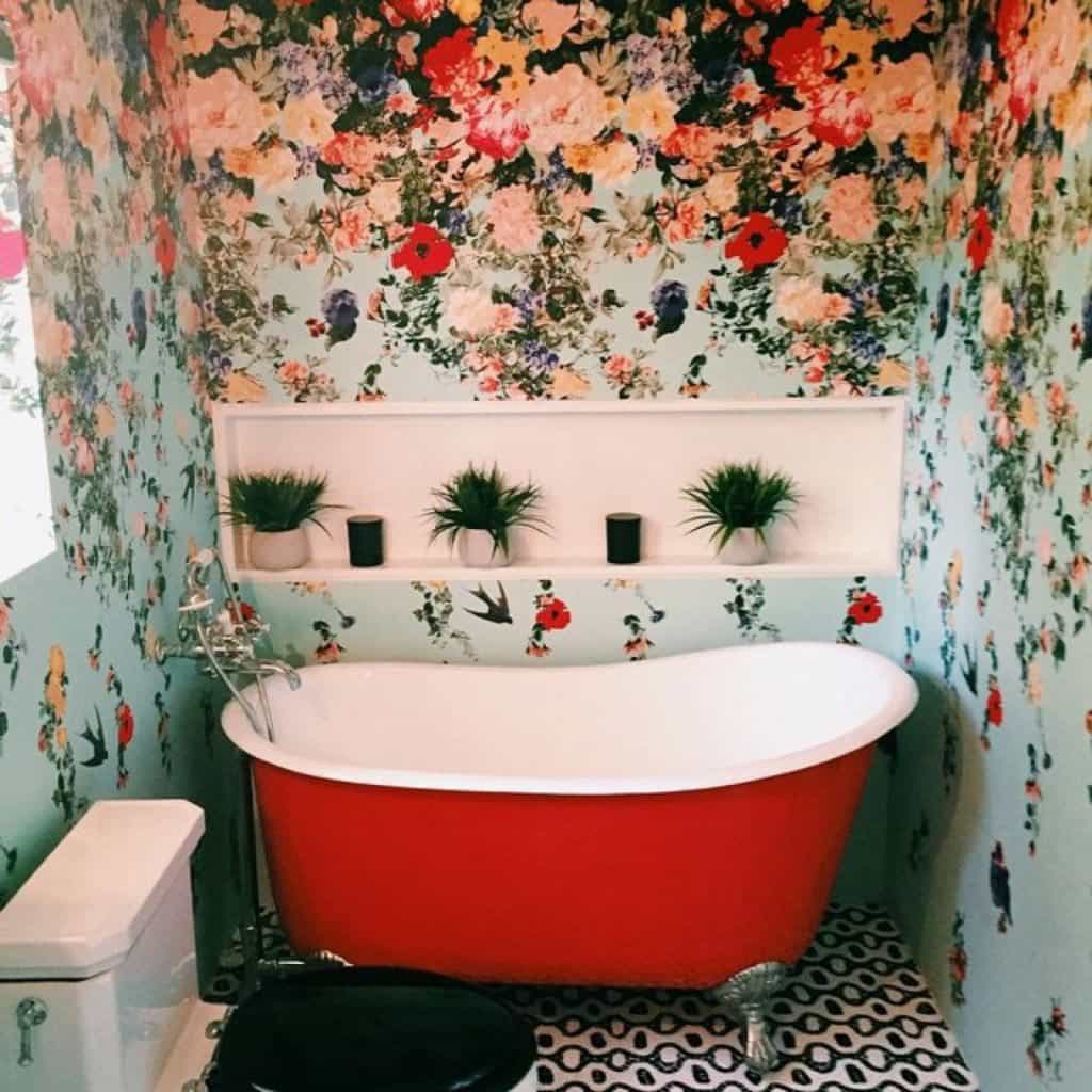 Pretty Bathroom With Red Clawfoot Tub And Floral Wallpaper