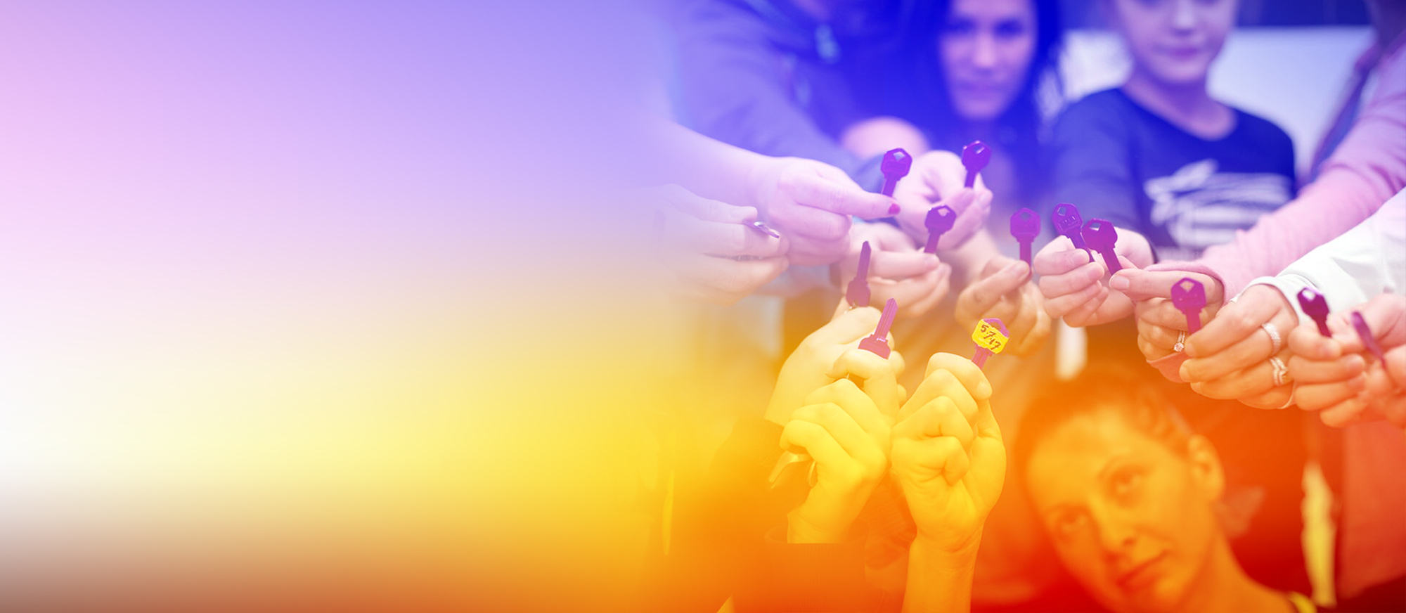 A group of people holding small purple objects, possibly keys or tokens, in a close-up shot. The image has a warm, vibrant color overlay