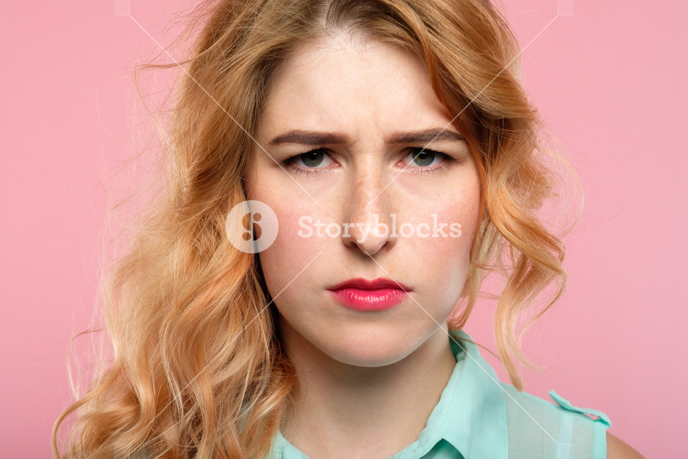 Serious Young Woman With A Troubled Look And Gathered Brows