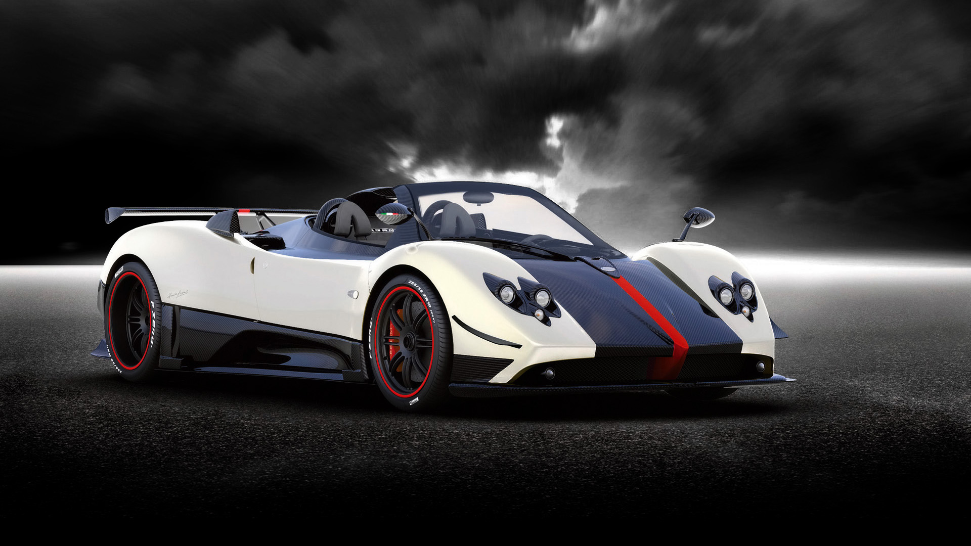 A stunning Pagani Huayra Roadster, gleaming white with black and red accents, parked on a dark asphalt surface under a dramatic, cloudy sky