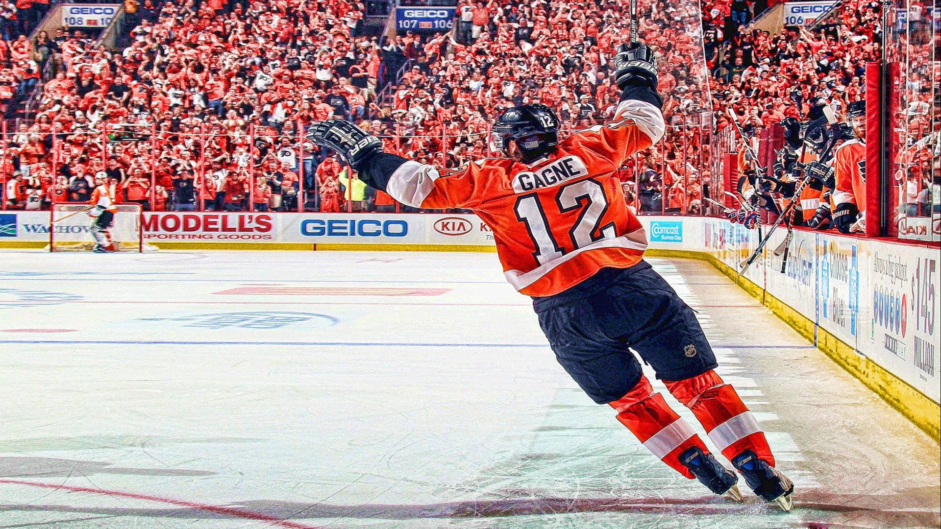 A hockey player celebrates a goal in front of a cheering crowd