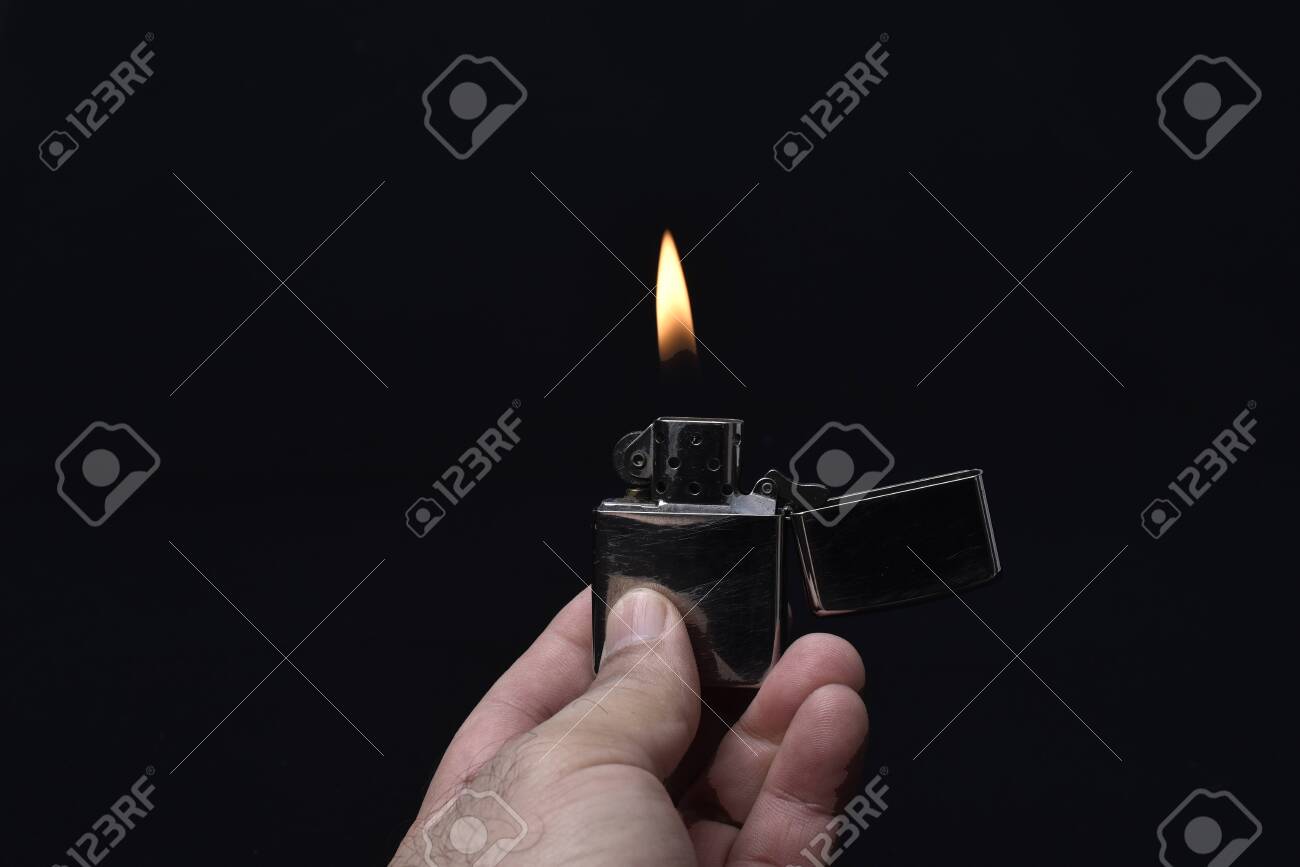 Free download Holding Lighter Lit On Black Background Stock Photo