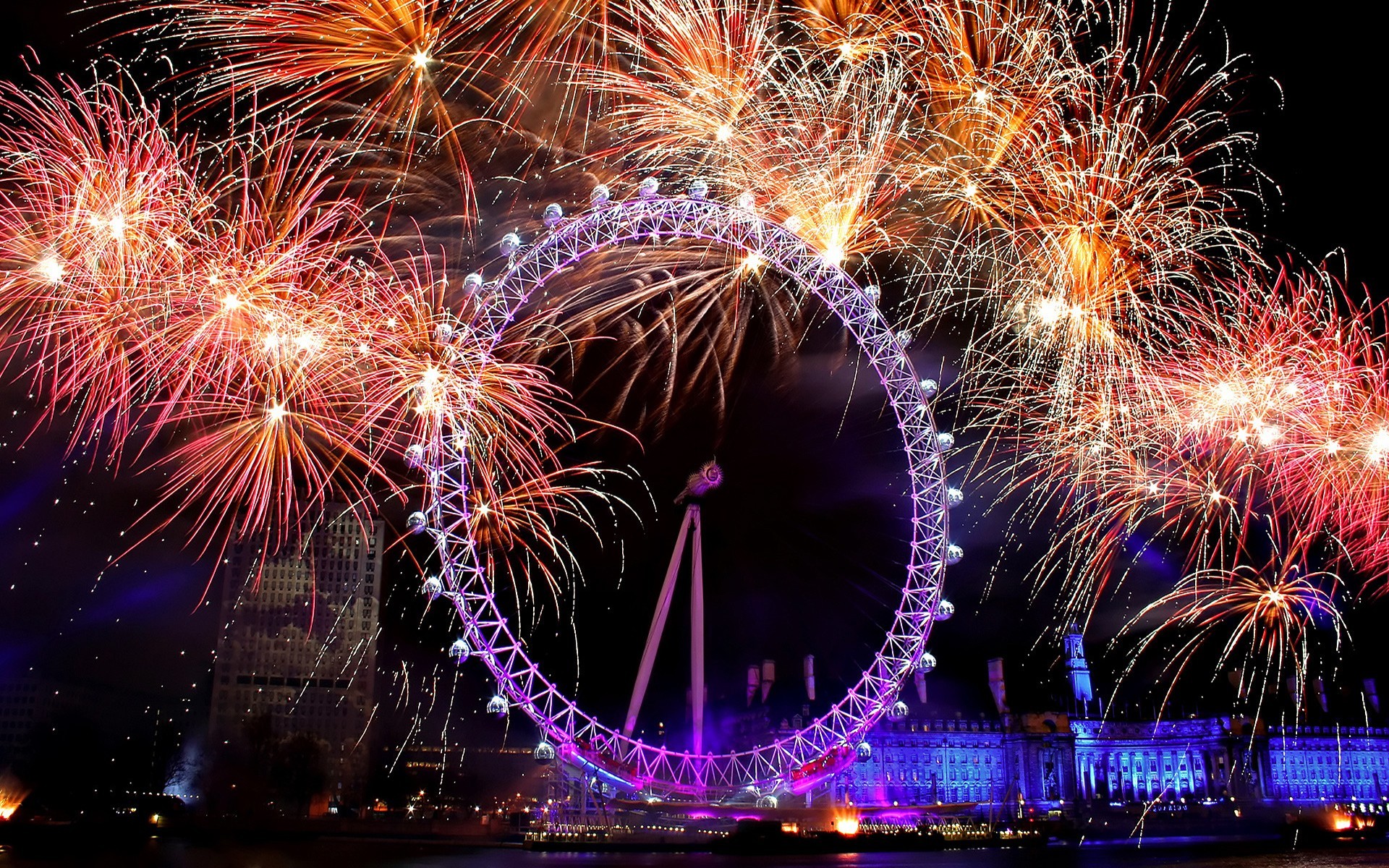 Fireworks exploding over the London Eye on New Year's Eve