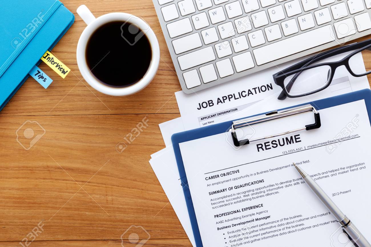 Resume And Job Application On Wood Desk Background For Search