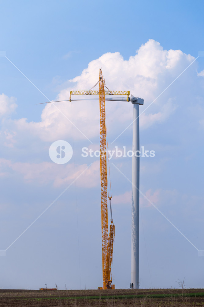 Yellow Crane Tower Placing Windmill Blade With Background Of Blue