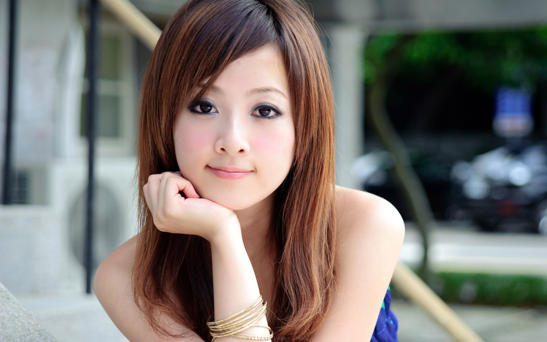 Beautiful young woman with brown hair and brown eyes posing in a soft, natural style