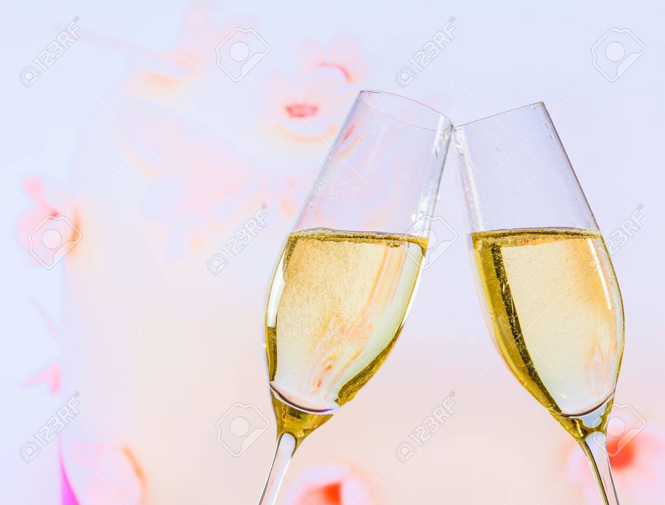 Champagne Flutes With Golden Bubbles Make Cheers On Wedding Cake