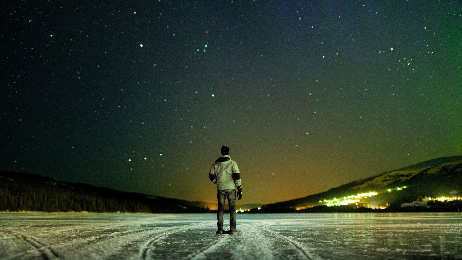 Man On Frozen Lake Looking At Stars Desktop Wallpaper