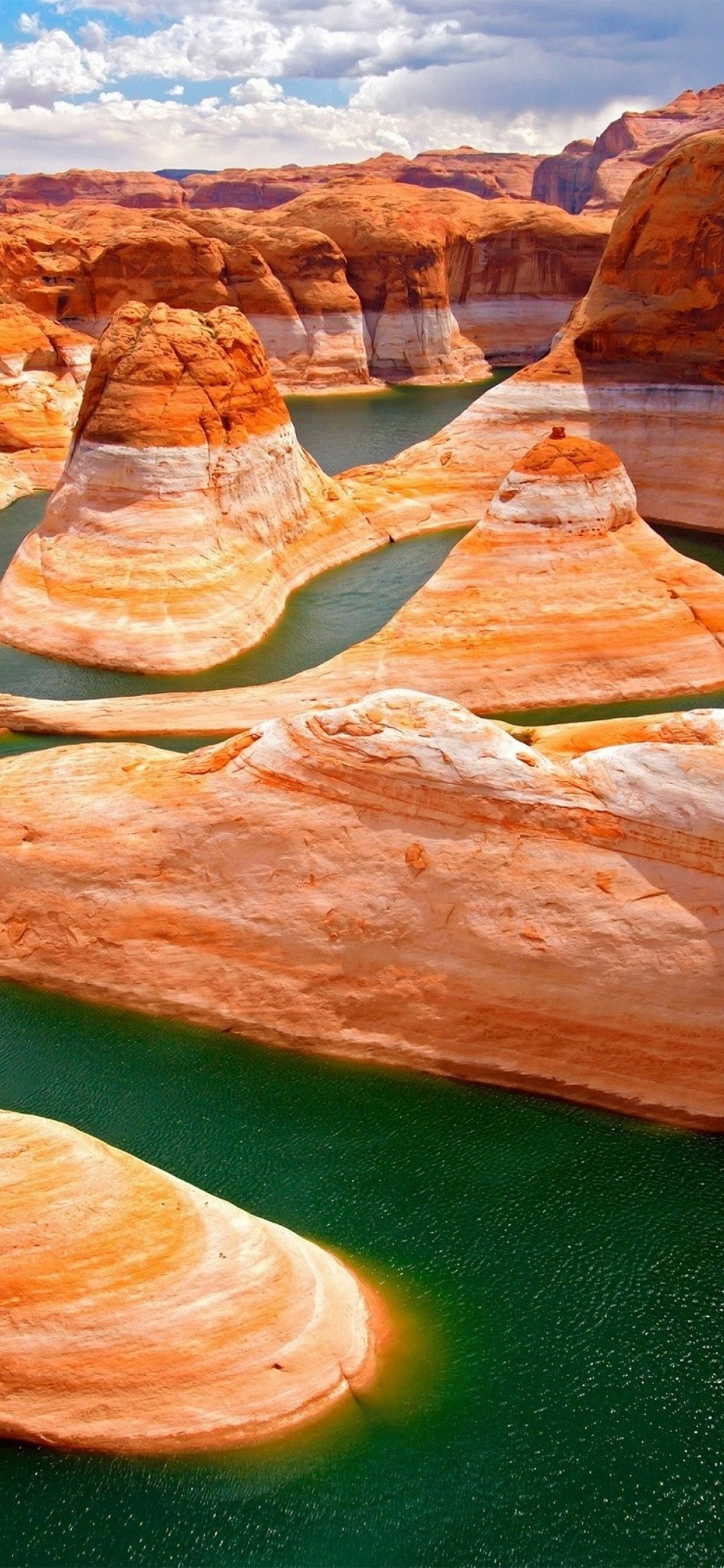 Stunning aerial view of Antelope Canyon with its vibrant orange and white sandstone formations and emerald green water