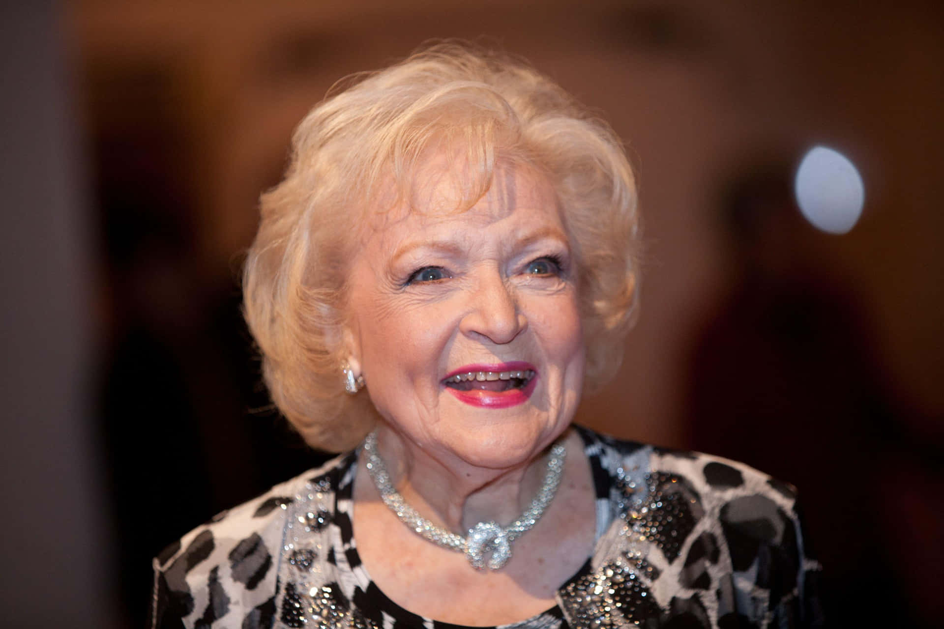 Betty White At A Hollywood Event Smiling Brightly Wallpaper