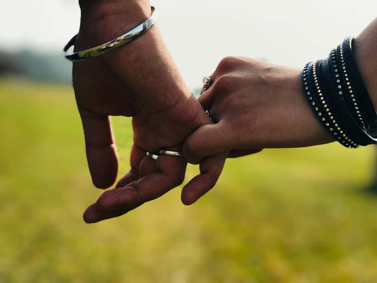 Couples Holding Hands To Symbolize Unity Wallpaper