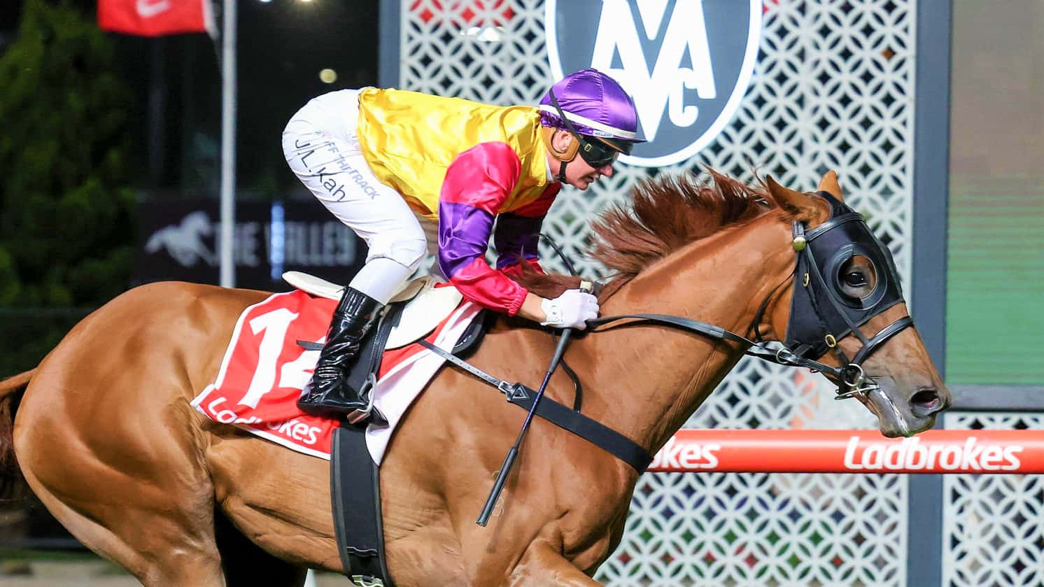 Jamie Kah Champion Jockey In Action Wallpaper