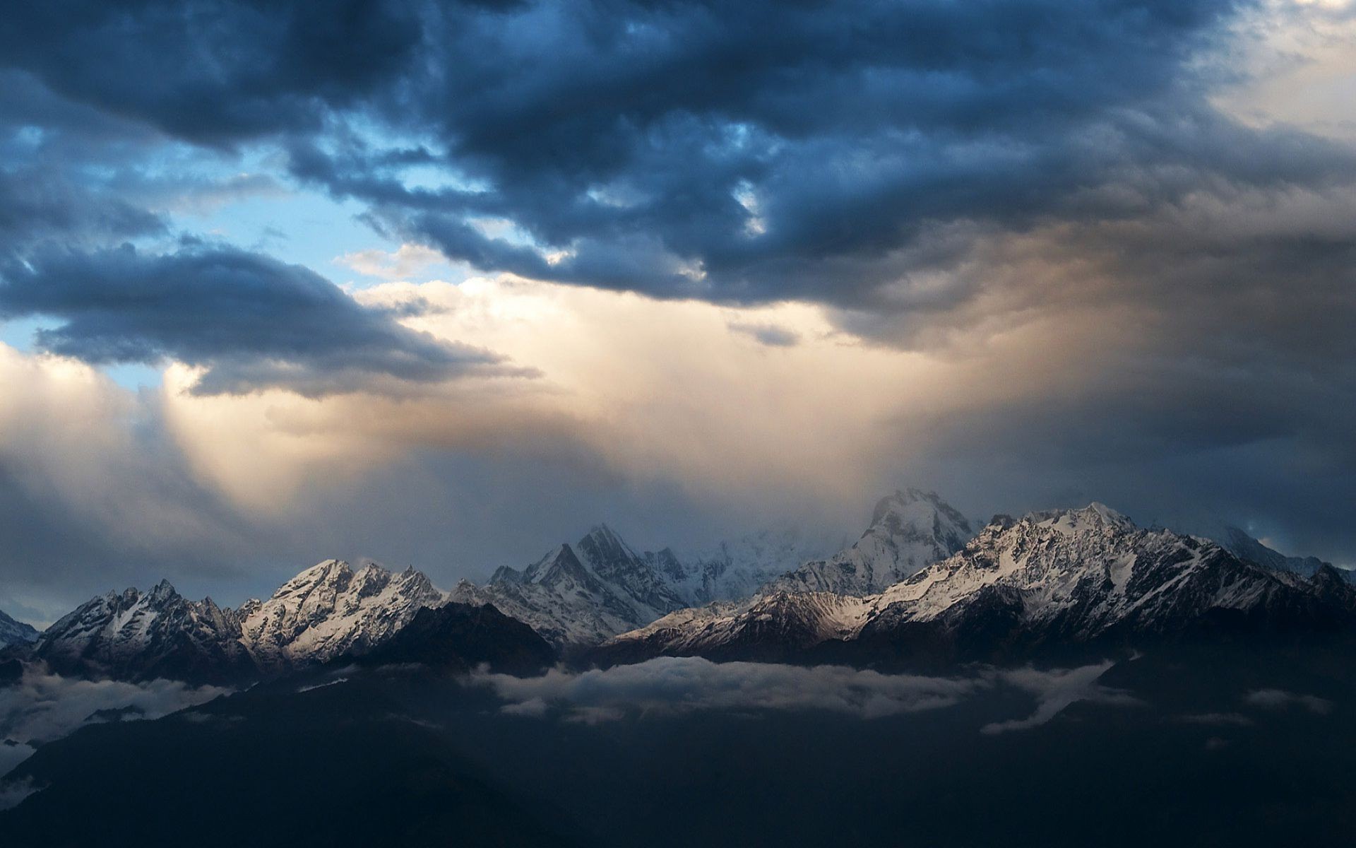 Storm clouds over the mountain peaks Widescreen Wallpaper