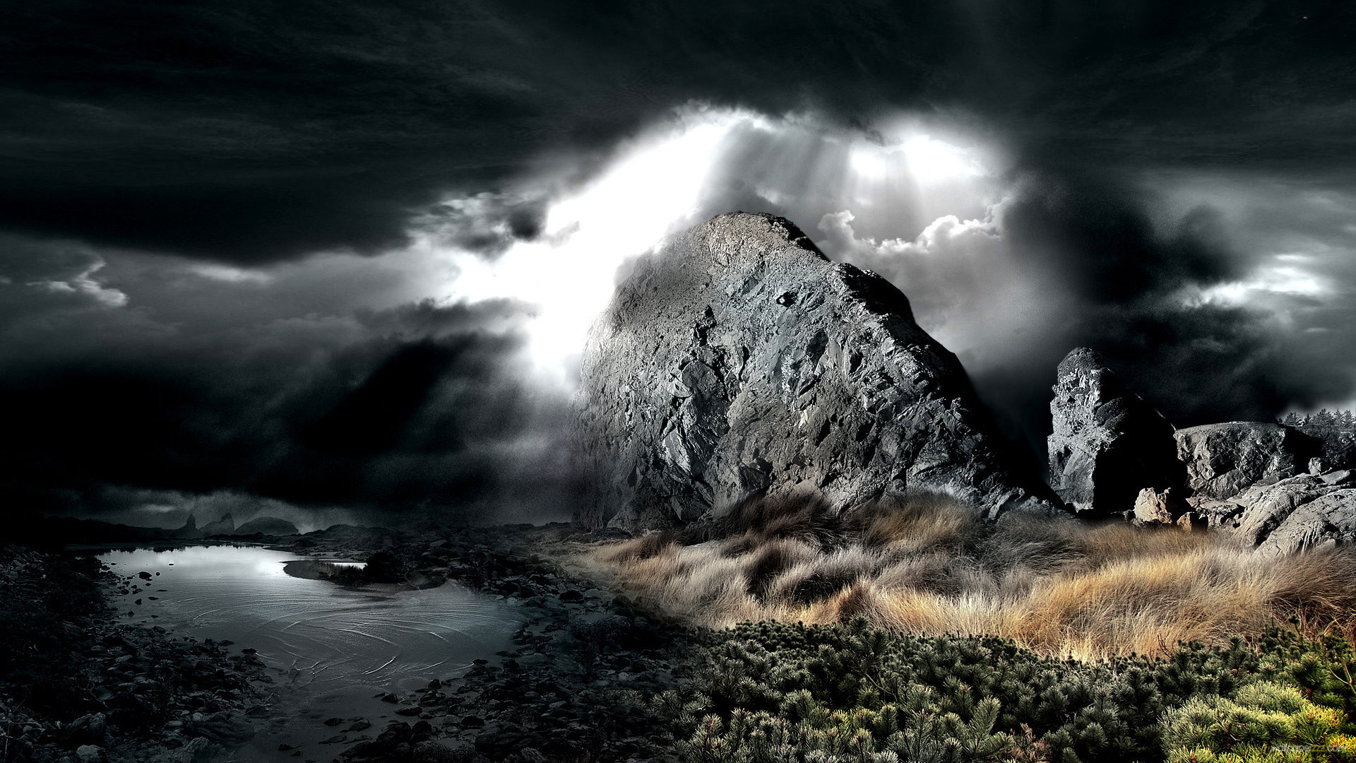 A dramatic landscape of dark, rocky mountains under a stormy sky with a patch of light breaking through the clouds, illuminating a small pond and grassy foreground