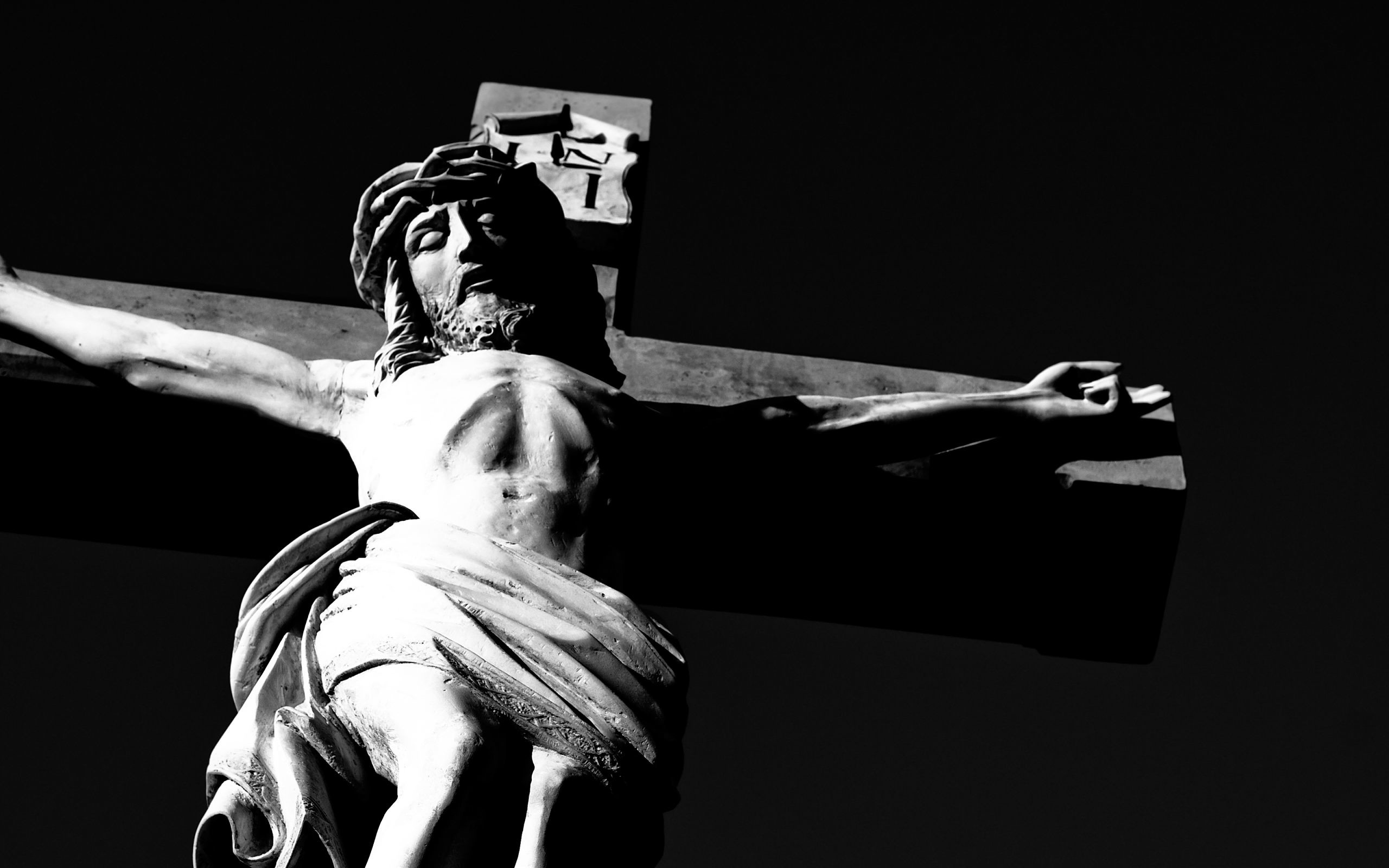 Black and white photograph of a statue of Jesus Christ on the cross