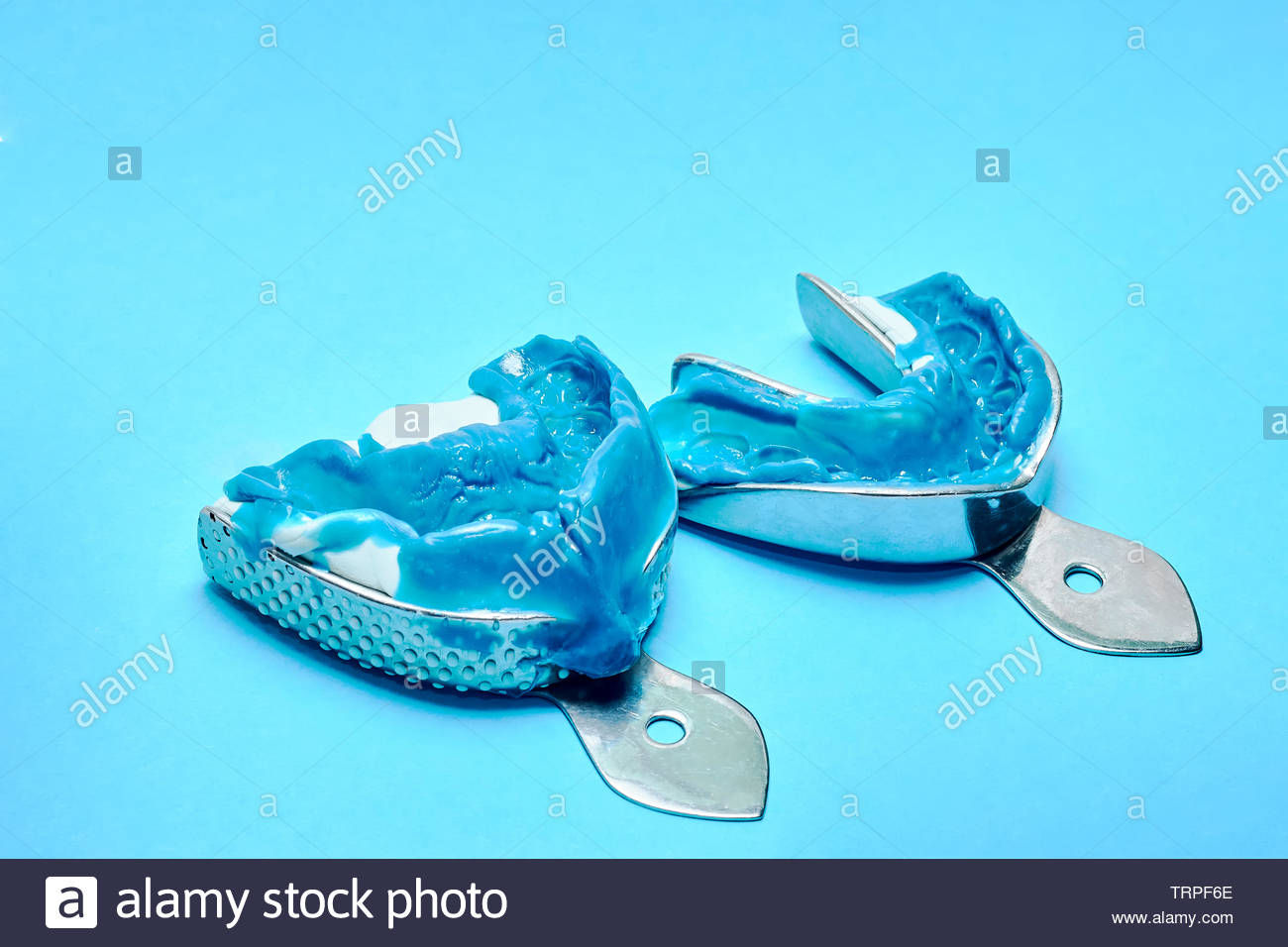 Two Dental Impressions On A Blue Background Molds From The