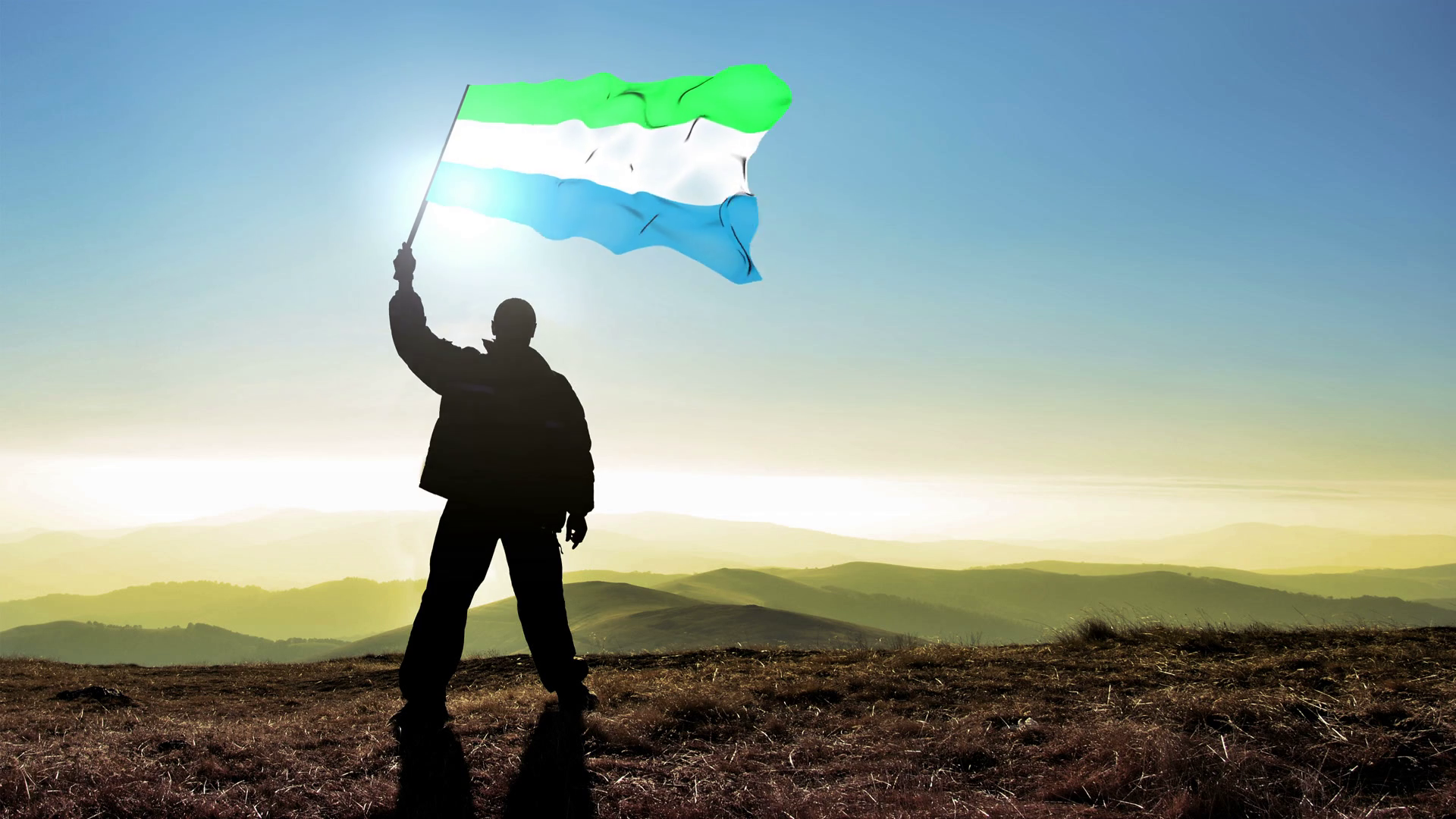 Successful Silhouette Man Winner Waving Sierra Leone Flag On Stock