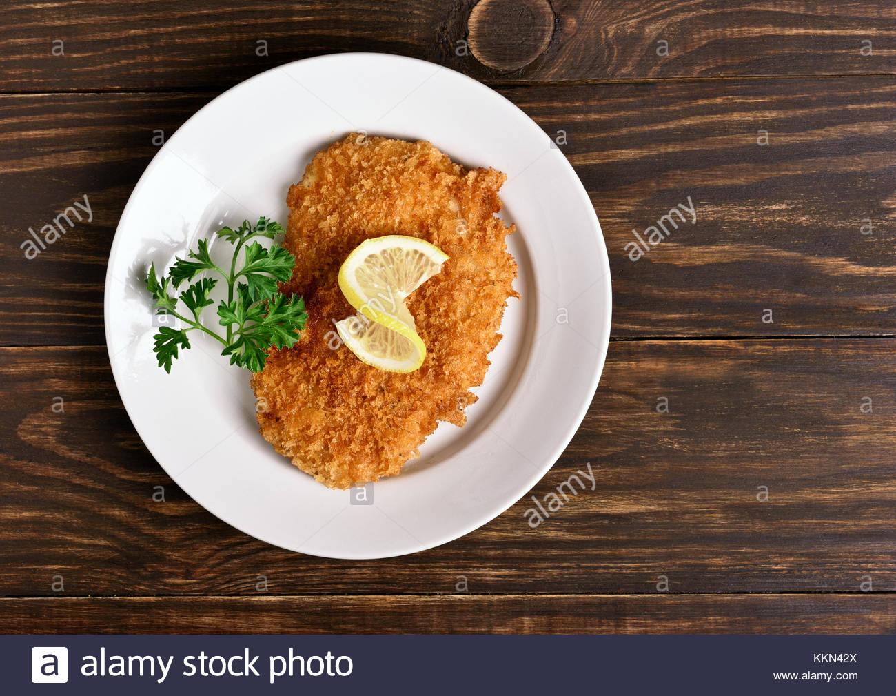 Free download Chicken schnitzel on plate over wooden background Top