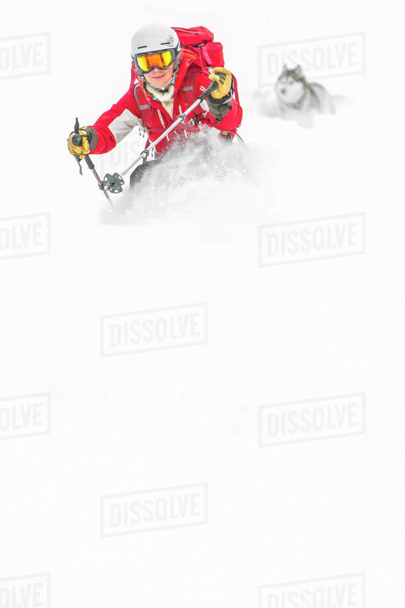 Female Backcountry Skier Wearing Ski Jacket And Goggles With