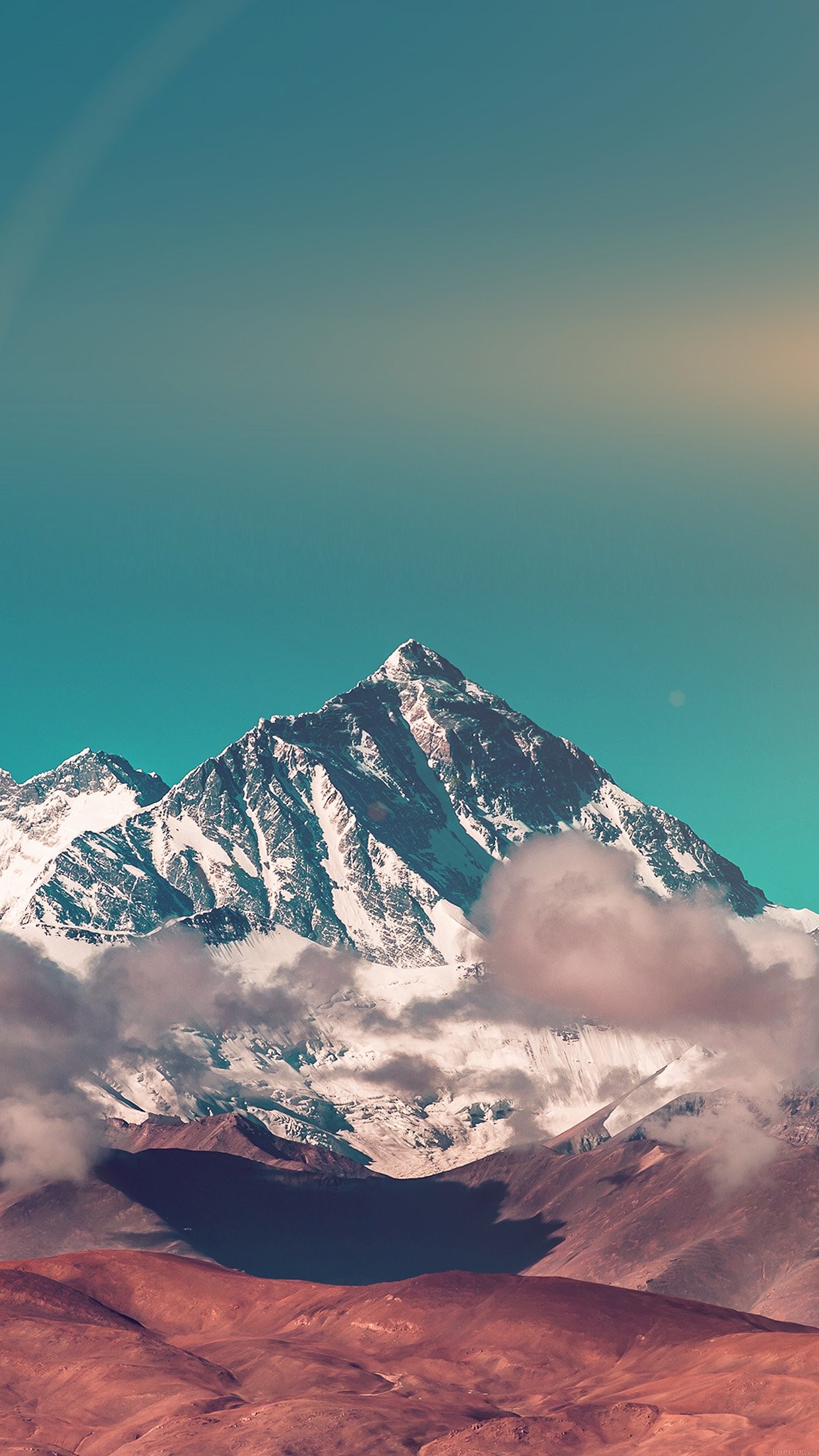 Majestic snow-capped mountain peak against a turquoise sky, suitable for phone wallpaper