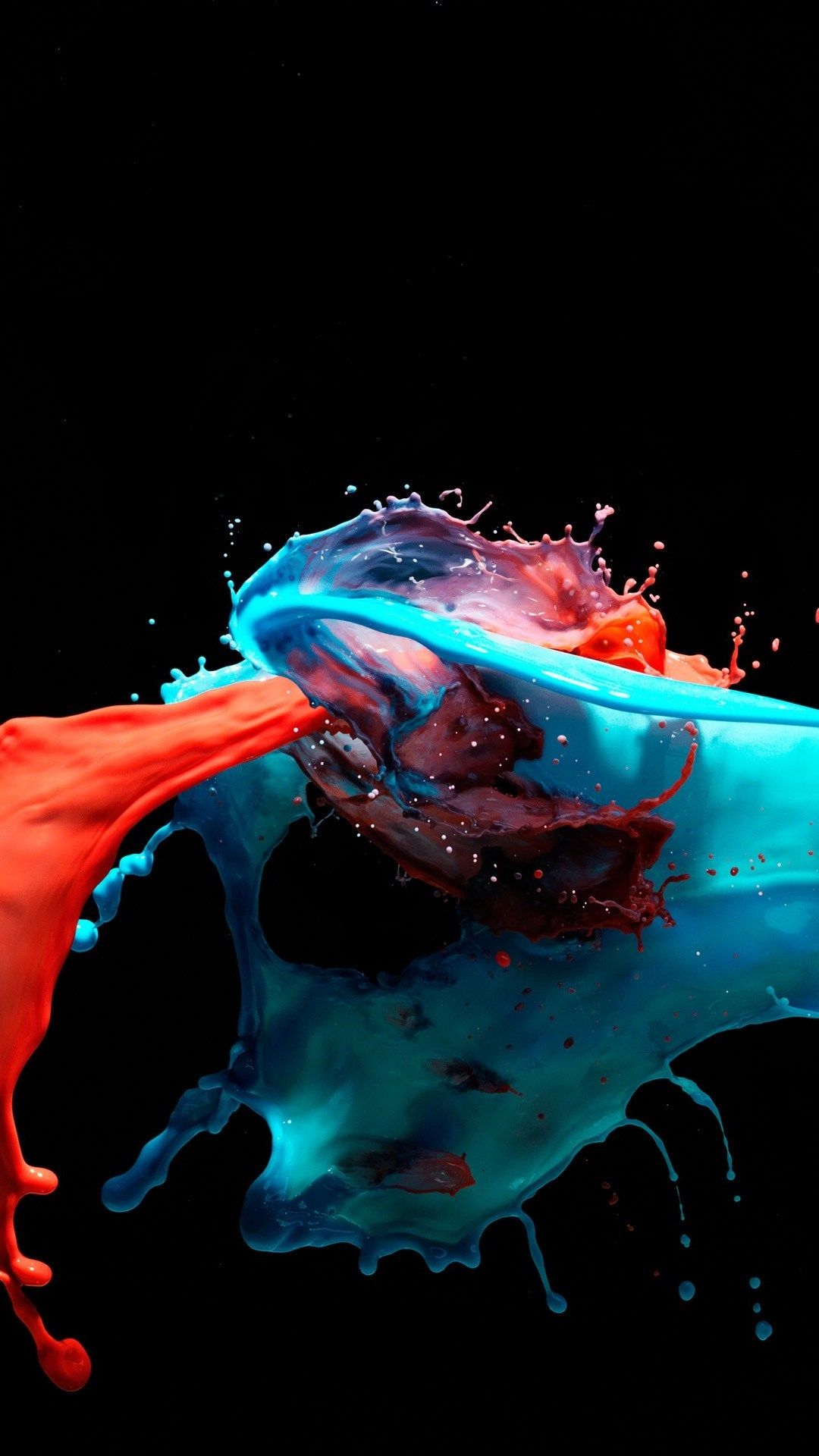 Abstract image of colliding red and blue paint splashes on a black background, creating a vibrant and dynamic visual