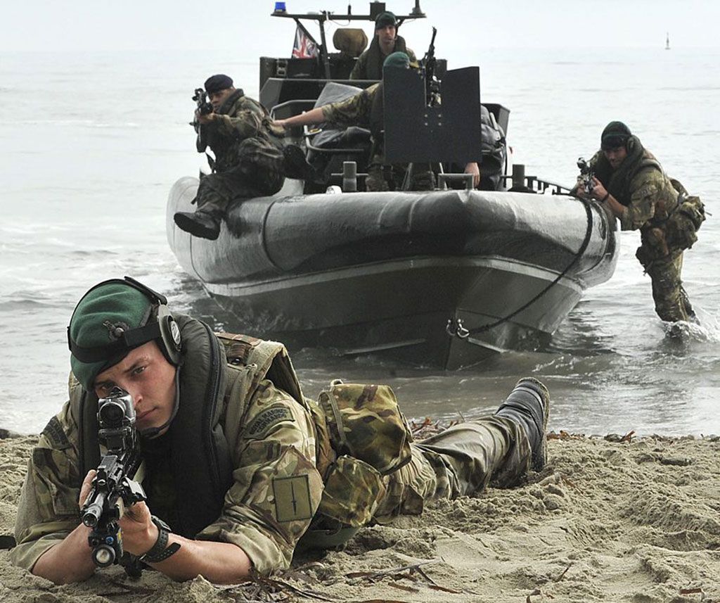 Commandos Marine disembarking from a rigid-hulled inflatable boat (RHIB) during an amphibious operation