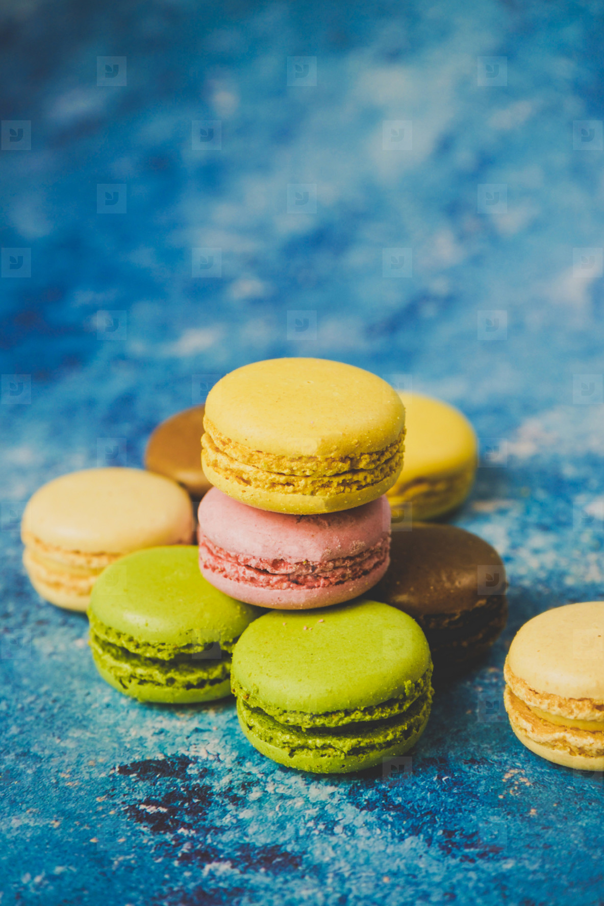 Photos Variety Of Colorful Macarons Over A Blue Background