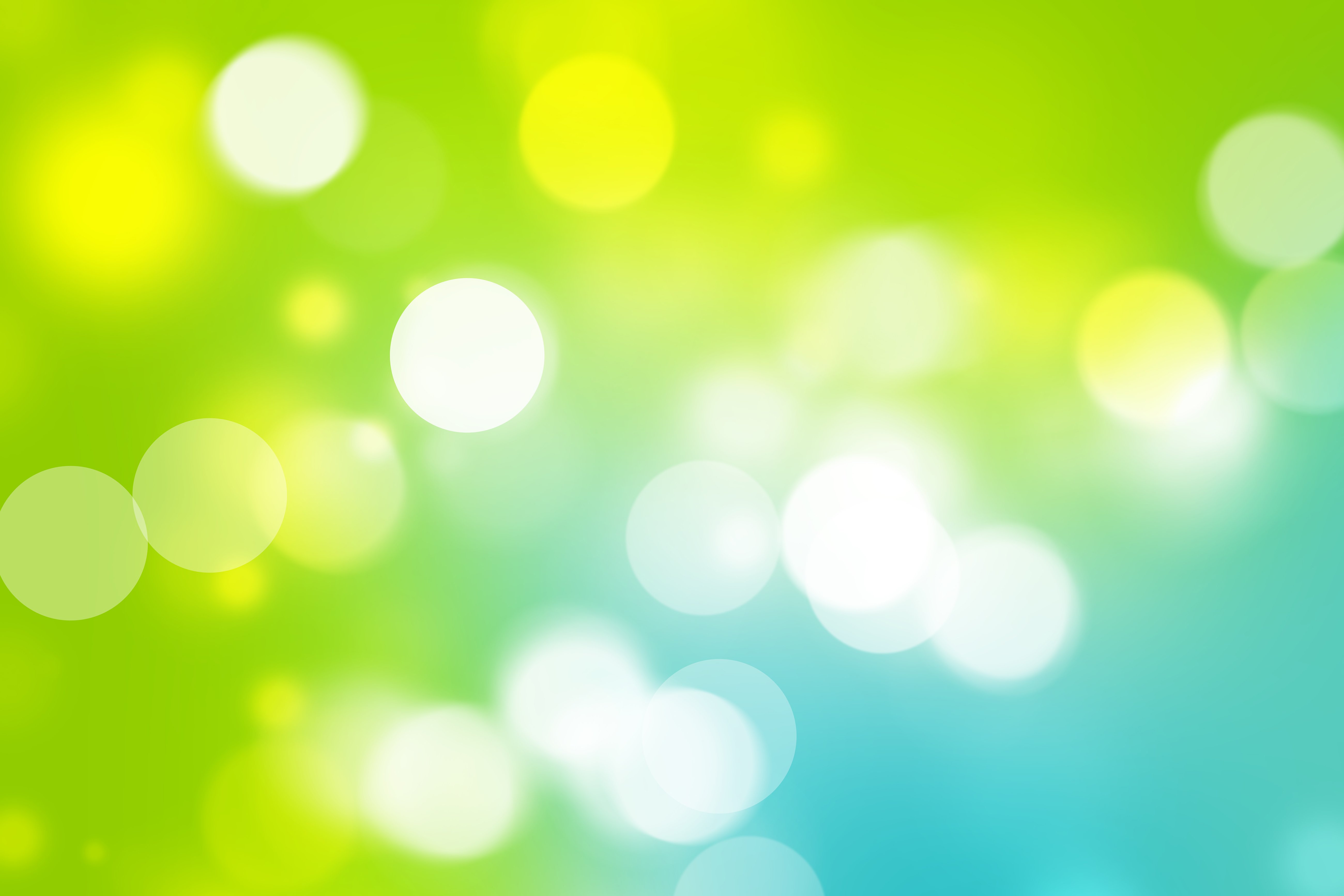 Abstract green and blue bokeh background with soft glowing circles