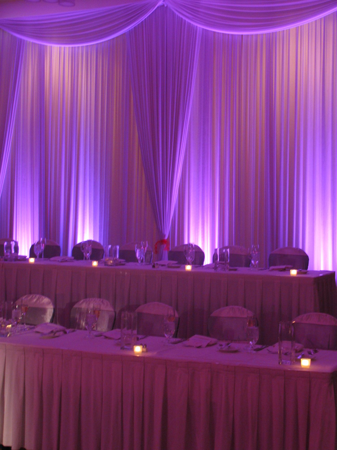 Gorgeous Head Table Backdrop With Curtains And Uplighting