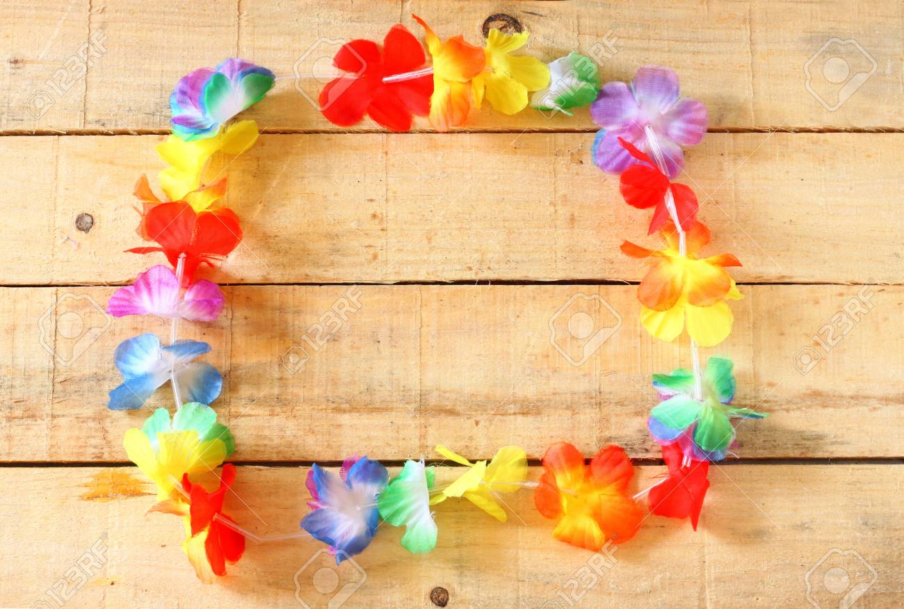 Necklace Of Bright Colorful Flowers Lei On Wooden Background Stock
