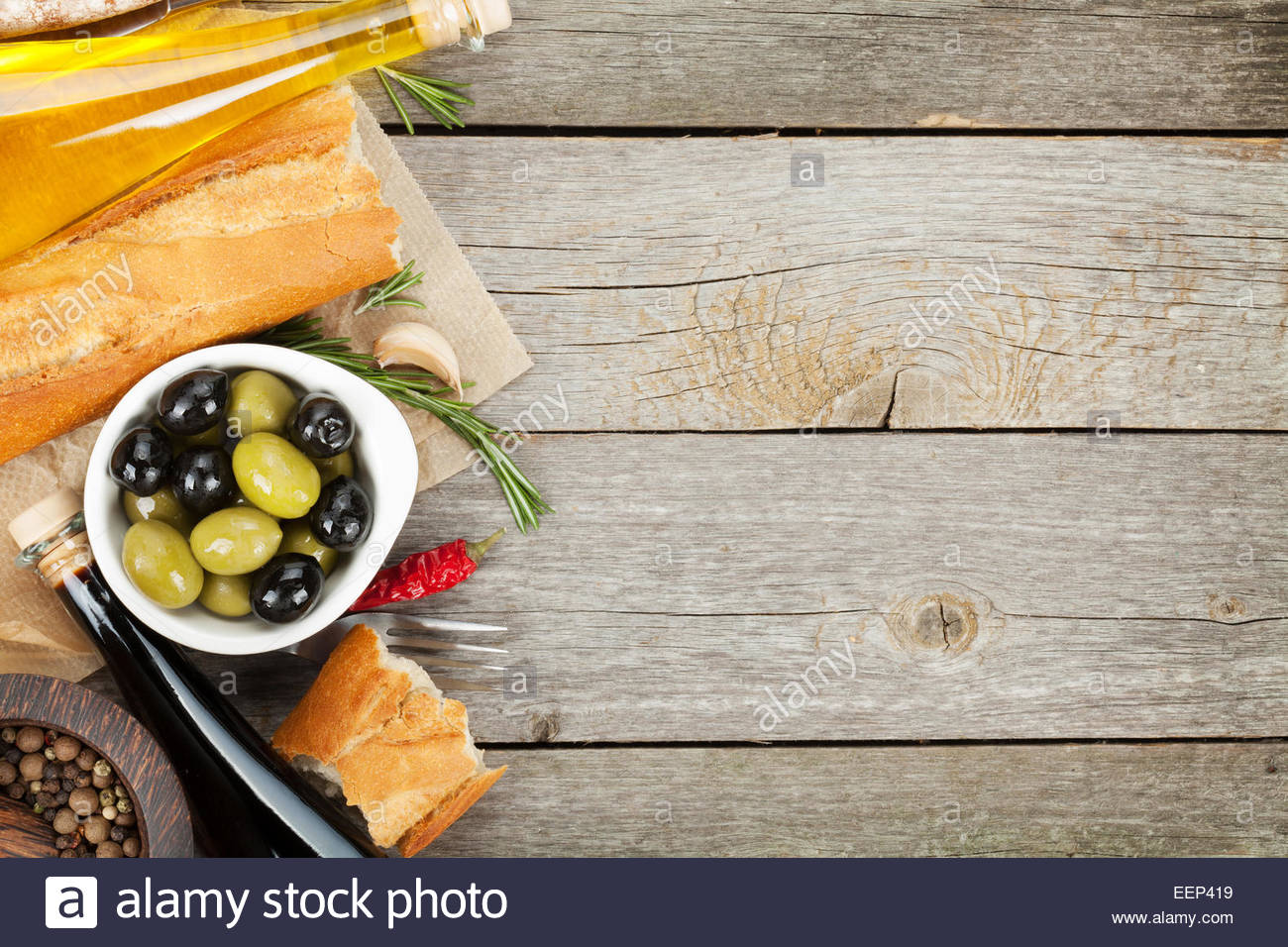 Italian Food Appetizer Of Olives Bread And Spices On Wooden Table