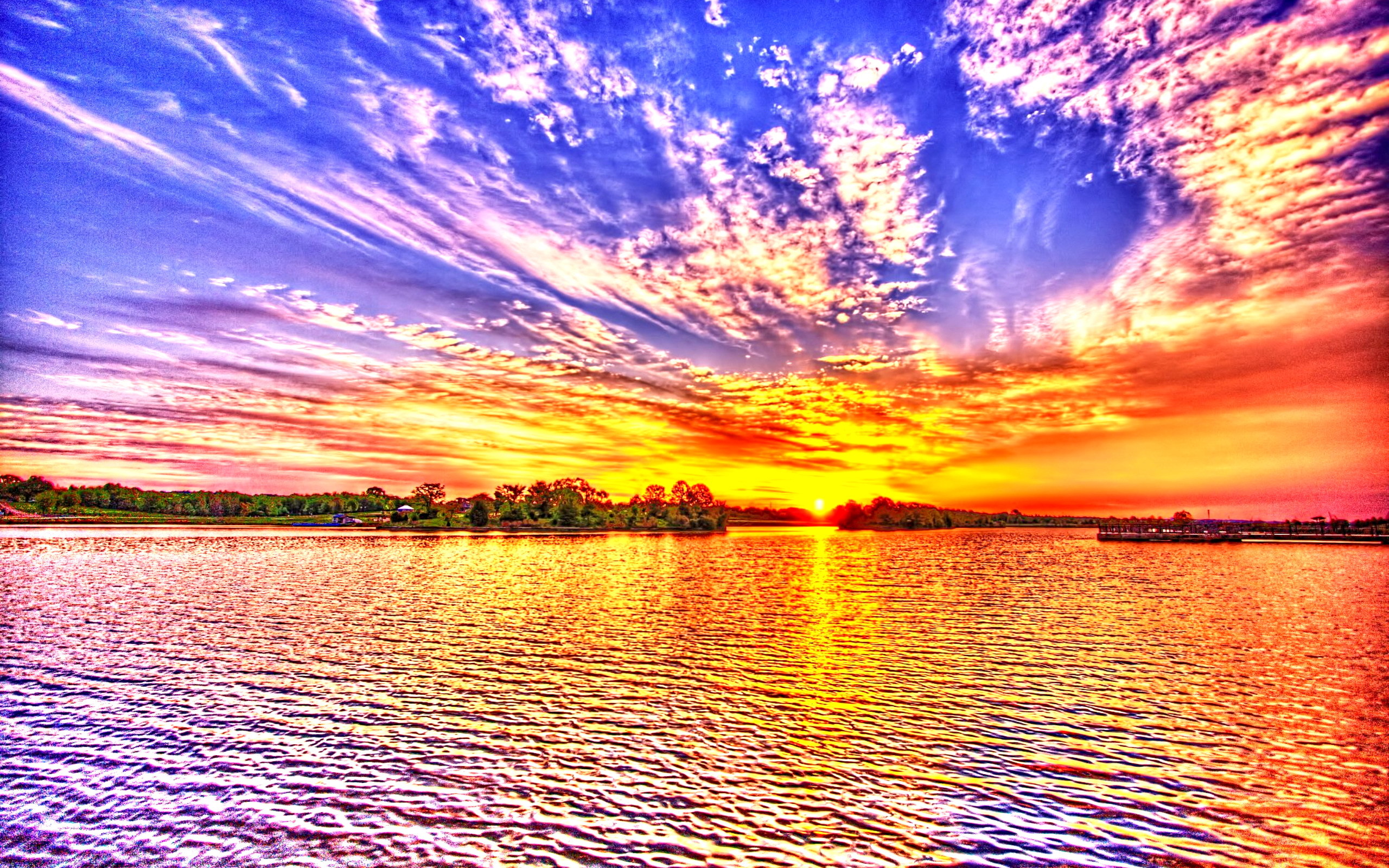 Vivid sunset over a lake with vibrant colors reflecting in the water