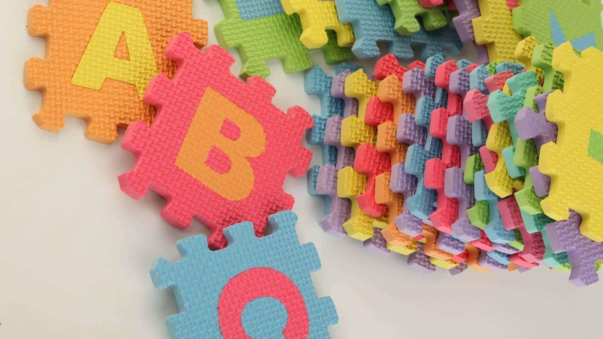 A Colorful Puzzle With Letters And Numbers Wallpaper