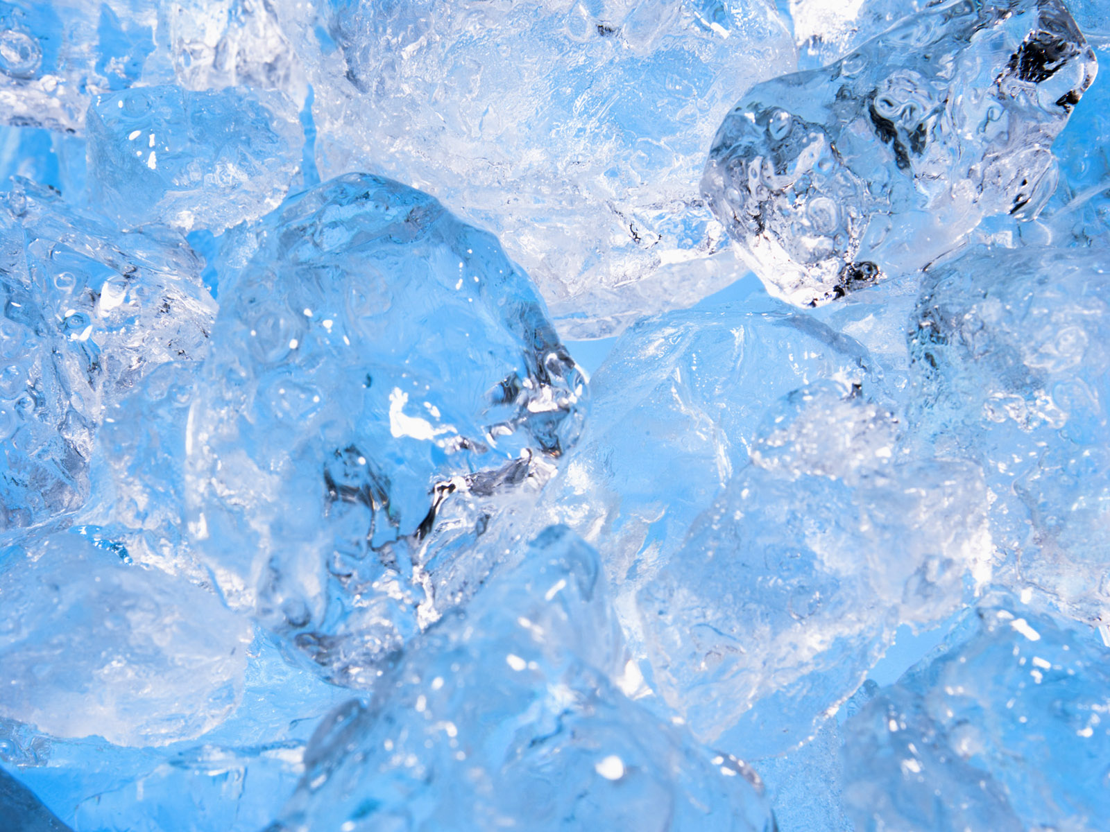 Close-up of glistening ice cubes, showcasing their cool, refreshing texture and translucent blue hues