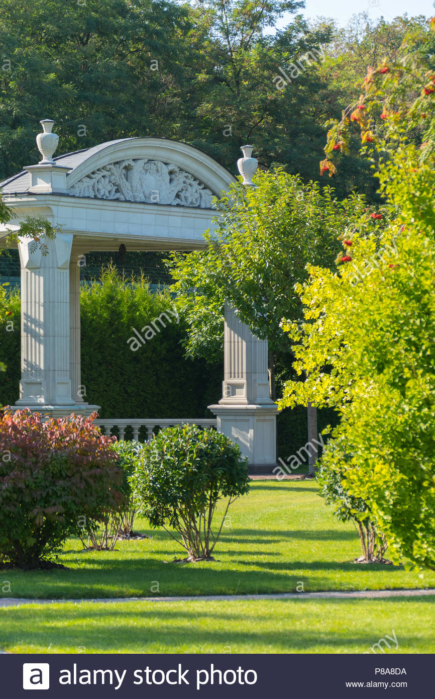 Stone Arbor With Large Pillars And Decorative Stucco Against The