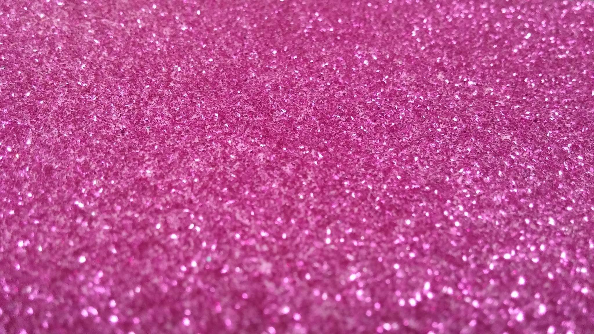 Close-up of a sparkly pink glitter background, perfect for adding a touch of glamor to digital designs